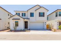 Charming two-story home featuring a two-car garage, neutral-toned exterior, and minimalist landscaping at 2205 N Peden Dr, Chandler, AZ 85225
