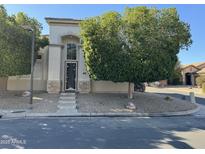 Charming single story home featuring a decorative steel front door and attractive desert landscaping at 2308 S Bernard --, Mesa, AZ 85209