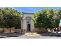 Charming two-story home featuring a stucco facade, decorative front door, and mature shade trees at 2308 S Bernard --, Mesa, AZ 85209