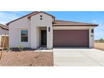 Charming single-story home featuring a two-car garage, desert landscaping, and a modern facade at 23443 W Albeniz Pl, Buckeye, AZ 85326