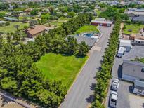 Expansive property featuring a sparkling pool, lush greenery, and ample parking at 25829 S Mandarin Dr, Queen Creek, AZ 85142