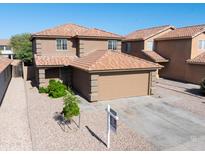 Two-story home featuring a two-car garage, neutral stucco exterior, and tile roof at 272 S 228Th Ln, Buckeye, AZ 85326