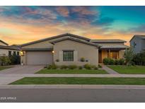 Charming single-story home with manicured lawn and desert landscaping at sunset at 3929 E Bloomfield Pkwy, Gilbert, AZ 85296