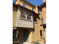 Exterior shot showcasing three-story building with stone accents and desert landscaping at 7722 W Pipestone Pl, Phoenix, AZ 85035