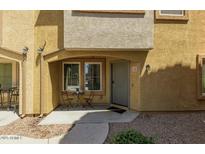 Inviting front entrance with covered porch and charming seating area for relaxing and welcoming guests at 7722 W Pipestone Pl, Phoenix, AZ 85035