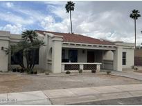 Charming single-story home with a terracotta roof, front porch and desert landscaping at 8343 E San Ricardo Dr, Scottsdale, AZ 85258