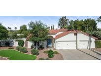 Beautiful home featuring a red tile roof, attached two car garage and a blue front door at 8943 N 80Th Pl, Scottsdale, AZ 85258
