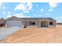 Charming single-story home featuring a gray facade, attached garage, and desert landscaping at 9280 W Wenden Dr, Arizona City, AZ 85123