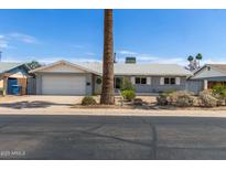Charming single-story home featuring a well-maintained yard and attached garage at 100 E Geneva Dr, Tempe, AZ 85282