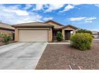 Charming single-story home with a well-maintained front yard, two car garage, and neutral color scheme at 10752 W Rio Vista Ln, Avondale, AZ 85323