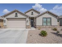Charming single-story home with a two-car garage and low-maintenance desert landscaping at 12048 E Chevelon Trl, Gold Canyon, AZ 85118