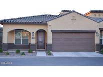 Inviting single-story home showcasing a well-maintained front yard, stylish brown garage door and desert landscaping at 1255 N Arizona Ave # 1216, Chandler, AZ 85225