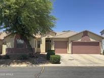 Charming single-story home featuring a two-car garage, desert landscaping, and a welcoming entrance at 45290 W Buckhorn Trl, Maricopa, AZ 85139