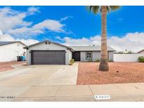 Charming single-story home featuring desert landscaping, a large palm tree, and a well-maintained front yard at 4815 W Charleston Ave, Glendale, AZ 85308
