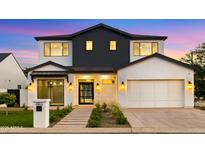 Stunning two-story modern home with a well-manicured lawn and a symmetrical design at 4911 E Amelia Ave, Phoenix, AZ 85018