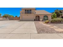 Charming home featuring a balcony, arched window, two-car garage, and low maintenance landscaping at 6101 W Sunnyside Dr, Glendale, AZ 85304