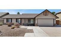 Charming single-story home with desert landscaping and a two-car garage at 6457 E Encanto St, Mesa, AZ 85205