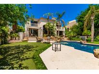 Expansive backyard featuring a putting green, luxurious pool, and desert landscaping, perfect for outdoor entertainment at 7475 E Gainey Ranch Rd # 4, Scottsdale, AZ 85258