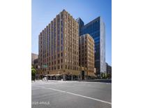 Tan brick building exterior on a corner, showing 1st Avenue sign on a clear sunny day in Phoenix, AZ at 114 W Adams St # 907, Phoenix, AZ 85003
