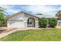Charming single-story home featuring a well-manicured lawn and an inviting arched entryway at 1241 S Alamo Cir, Mesa, AZ 85204