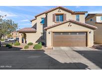 Inviting two-story home featuring an attached two-car garage and well-maintained landscaping at 1255 N Banning --, Mesa, AZ 85205