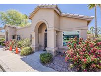 Charming single-story home featuring an arched entryway and well-maintained landscaping at 14300 W Bell Rd # 261, Surprise, AZ 85374