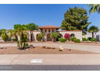 Charming single-story home with mature landscaping, circular driveway, and desert rock front yard at 14828 N Skokie Ct, Phoenix, AZ 85022