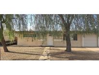 Charming single-story home featuring a well-maintained gravel yard, stone pathway, and mature tree at 1526 W Huntington Dr, Tempe, AZ 85282