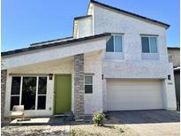Charming two-story home with a bright green front door and a brick paver driveway at 16027 N 74Th Ln, Peoria, AZ 85382