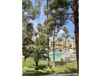 Relaxing community pool surrounded by lush landscaping and plenty of lounge chairs at 19400 N Westbrook Pkwy # 216, Peoria, AZ 85382