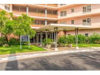 Inviting entrance to Phoenix Towers with covered entry, lush landscaping, and clear signage at 2201 N Central Ave # 3D, Phoenix, AZ 85004