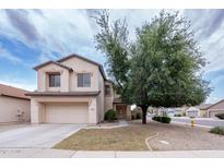 Charming two-story home featuring a well-manicured front yard with a mature shade tree and attached two-car garage at 231 N Nash Way, Chandler, AZ 85225