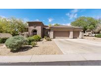 Charming single-story home boasting a three-car garage and desert landscaping at 30434 N Palo Brea Dr, Scottsdale, AZ 85266