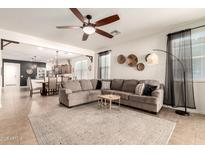 Inviting living room with open floor plan, neutral tones, and tile flooring throughout at 36203 N Urika Dr, San Tan Valley, AZ 85140