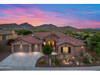 Stunning exterior of the home with well manicured landscaping and a three car garage at 42037 N Bradon Way, Phoenix, AZ 85086