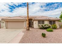 Charming single-story home featuring a well-maintained yard and a two-car garage, complemented by colorful landscaping at 4292 E Terrace Ave, Gilbert, AZ 85234
