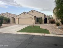 Charming single-story home featuring a well-maintained front yard and attached two-car garage at 43845 W Elizabeth Ave, Maricopa, AZ 85138