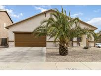 Charming single story house featuring a desert landscaped front yard and a two-car garage at 46185 W Dutchman Dr, Maricopa, AZ 85139