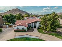 Stunning aerial view of the home showcases its well-manicured front yard and mountain backdrop at 5602 W Alameda Rd, Glendale, AZ 85310