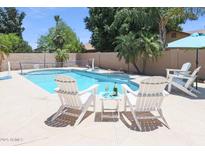 Sparkling pool with Adirondack chairs, perfect for relaxing and enjoying the outdoors at 6101 W Grandview Rd, Glendale, AZ 85306