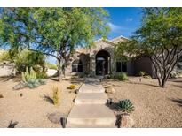 Stunning home featuring professionally landscaped front yard, mature trees, and a stone pathway at 6765 E Duane Ln, Scottsdale, AZ 85266