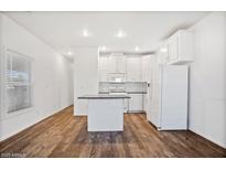 Bright kitchen features white cabinetry, modern appliances, and an island for extra counter space at 7807 E Main St # F36, Mesa, AZ 85207