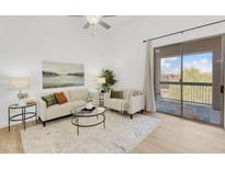 Bright living room with modern decor, stylish furnishings, and a sliding glass door to the balcony at 20801 N 90Th Pl # 271, Scottsdale, AZ 85255