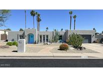 Charming single-story home with a blue door and desert landscaping at 2426 E Turquoise Dr, Phoenix, AZ 85028