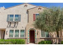 Inviting two-story home featuring stucco siding, colorful shutters, a charming entrance, and lush landscaping at 2660 S Equestrian Dr # 103, Gilbert, AZ 85295