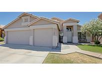 Charming single Gathering home with a well-manicured lawn, three car garage, and a welcoming entrance at 287 W Liberty Ln, Gilbert, AZ 85233