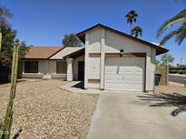 Charming single-story home featuring a well-maintained yard and attached garage in quiet neighborhood at 3002 W Tonopah Dr, Phoenix, AZ 85027