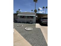 Charming single-story home with a covered porch and desert landscaping showcasing a neatly kept exterior at 4065 E University Dr # 242, Mesa, AZ 85205