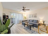 Comfortable living room with natural light, ceiling fan, and a view to the outdoor space at 540 N May -- # 2110, Mesa, AZ 85201