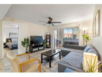 Bright living room with sliding door access, ceiling fan, and views to an adjacent bedroom at 540 N May -- # 2110, Mesa, AZ 85201